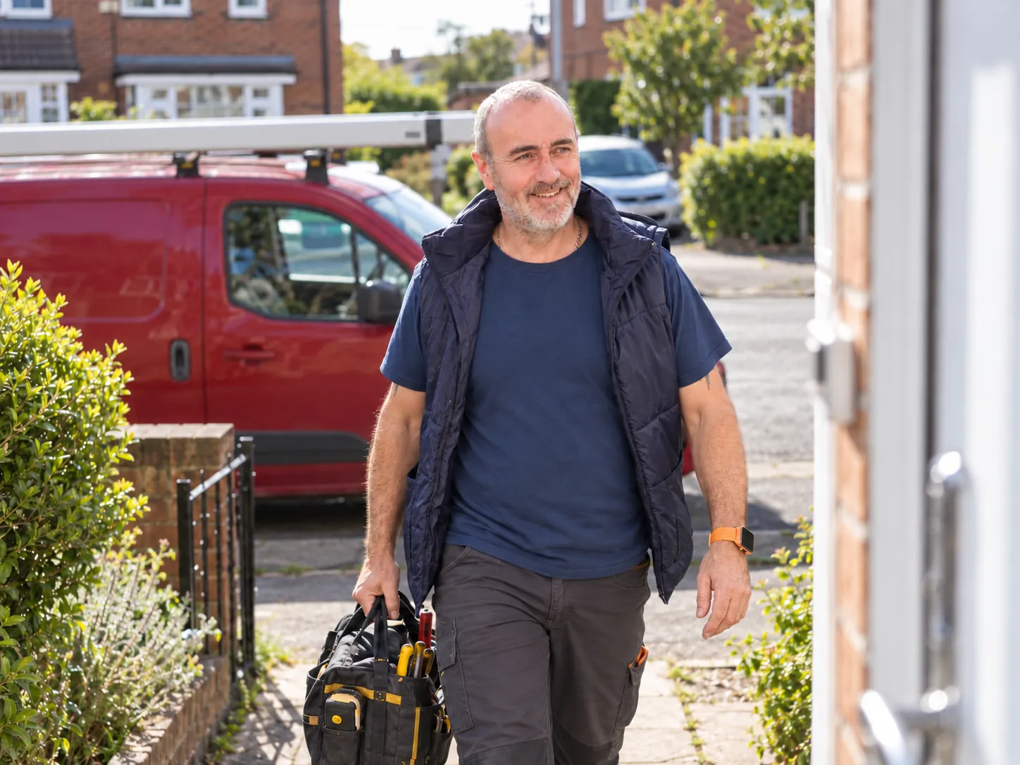 John Hargreaves with a tool bag beside his van